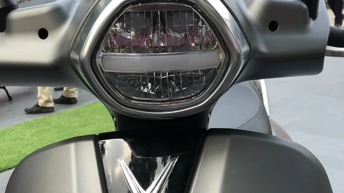 Lampu depan LED pada skuter VinFast Klara dengan garis lampu senja di tengah dan reflektor bersegmen di bawahnya